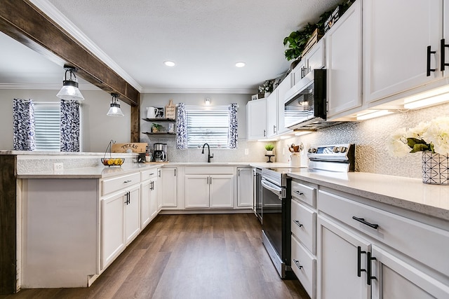 kitchen with stainless steel appliances, a sink, white cabinets, backsplash, and crown molding