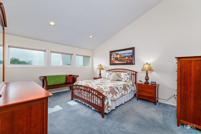 bedroom with vaulted ceiling, carpet floors, and a textured ceiling