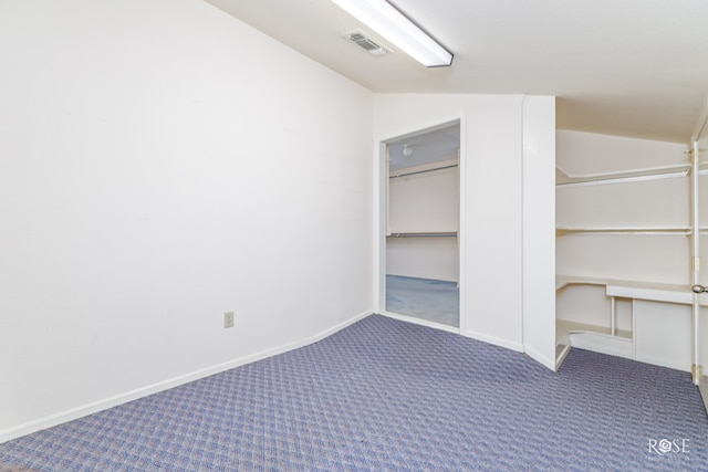 interior space featuring vaulted ceiling, carpet, and a closet