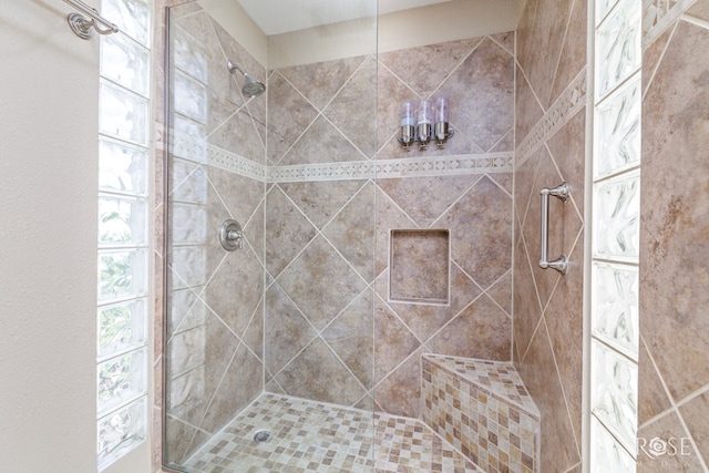 bathroom with a shower with door