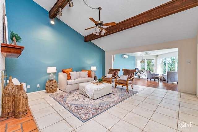 tiled living room with a textured ceiling, track lighting, lofted ceiling with beams, and ceiling fan