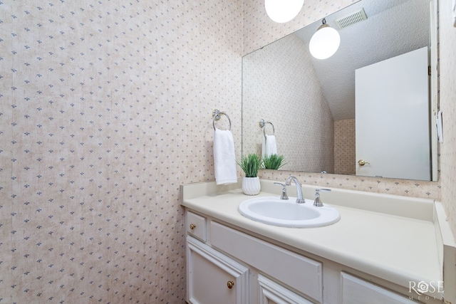 bathroom with vanity and vaulted ceiling