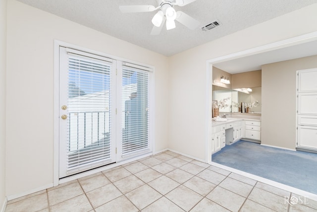 tiled spare room featuring ceiling fan and a textured ceiling