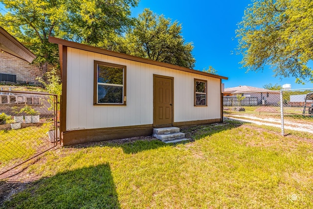 view of outbuilding featuring a yard