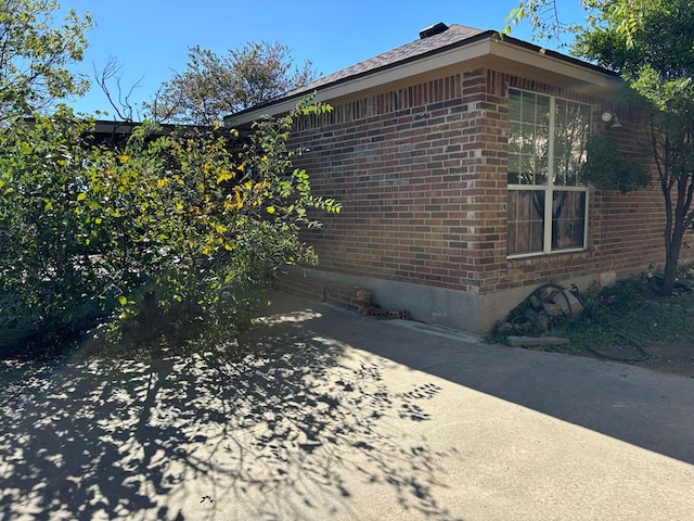 view of side of property with a patio