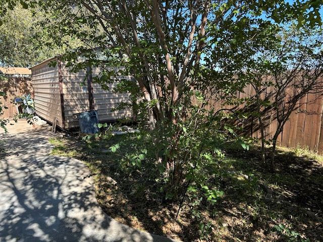 view of side of home with a storage shed