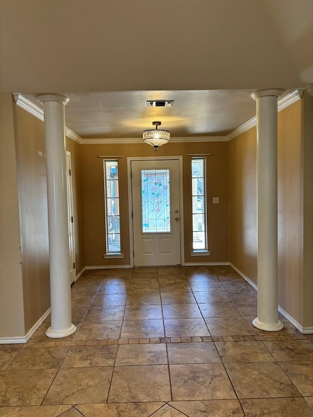 foyer entrance with ornamental molding and decorative columns