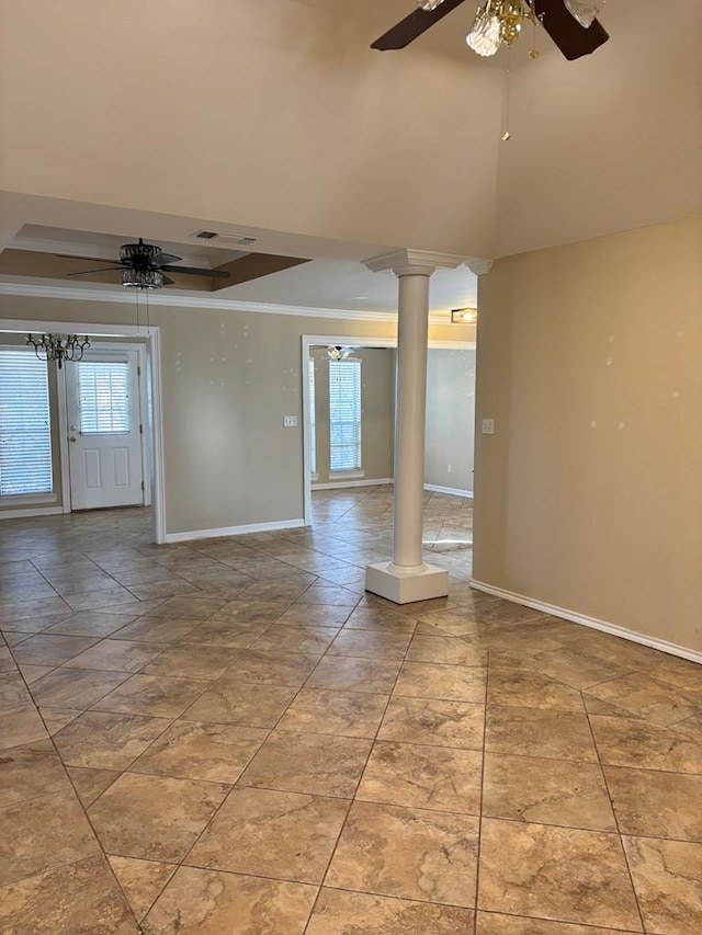 spare room with ornate columns, a raised ceiling, ornamental molding, and ceiling fan