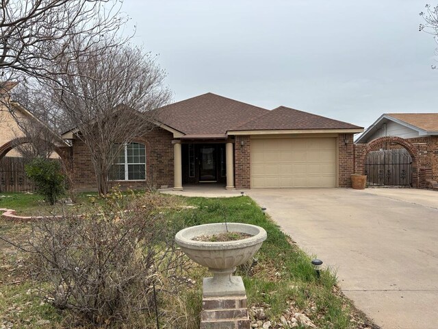 ranch-style home with a garage and a front lawn