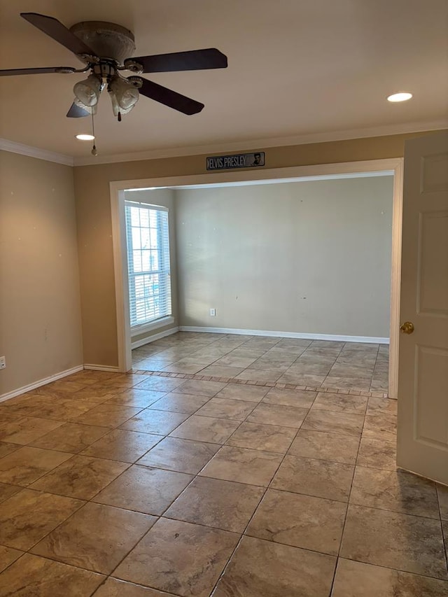 spare room featuring crown molding and ceiling fan