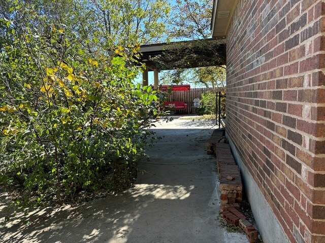 view of property exterior with a patio area