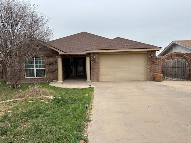 ranch-style house with a garage and a front lawn