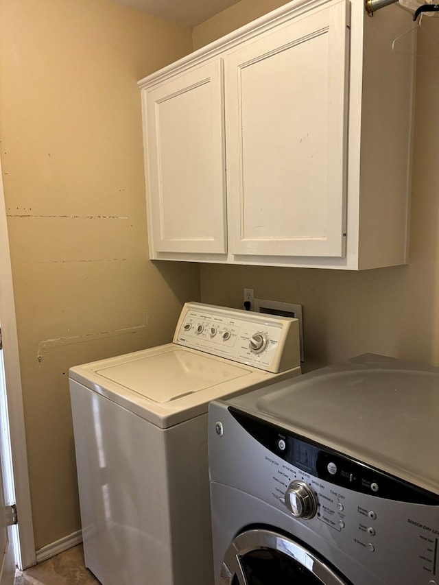 laundry area featuring cabinets and washing machine and clothes dryer