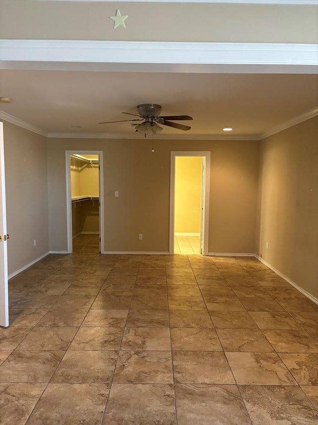 empty room with ornamental molding and ceiling fan