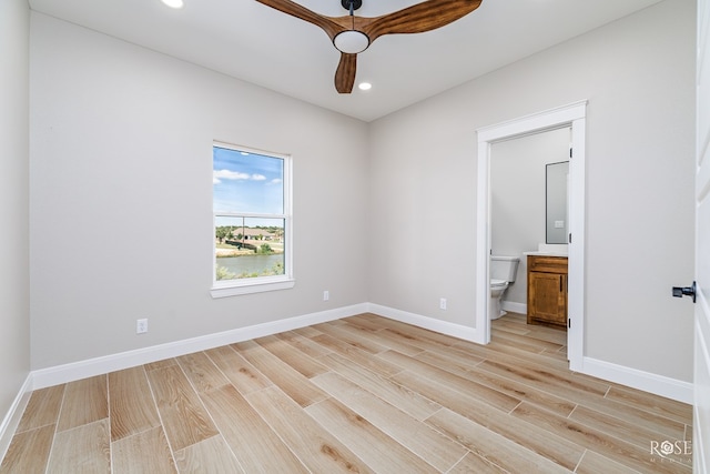 unfurnished bedroom featuring light hardwood / wood-style flooring, ceiling fan, and ensuite bathroom