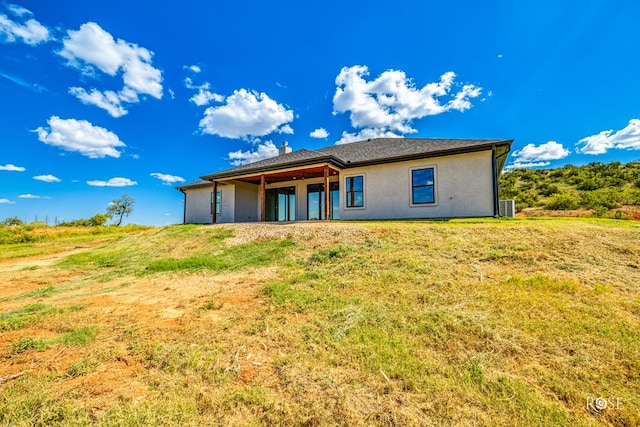 rear view of house with a lawn