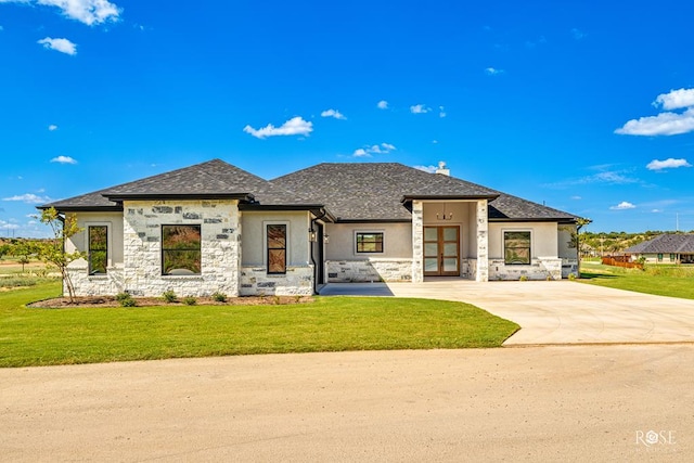 view of front of property featuring a front yard and french doors