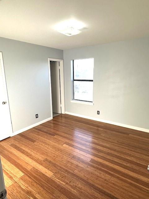 empty room with hardwood / wood-style floors