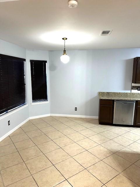 unfurnished dining area with light tile patterned floors