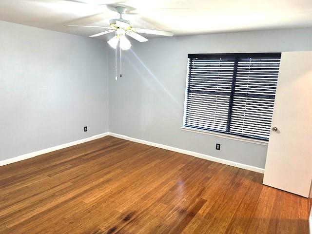 empty room featuring hardwood / wood-style flooring and ceiling fan