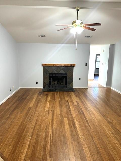 unfurnished living room featuring hardwood / wood-style floors and ceiling fan