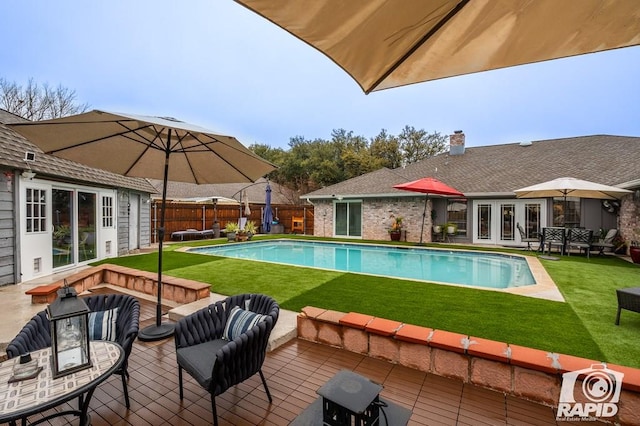 view of pool featuring a yard, an outdoor hangout area, and french doors