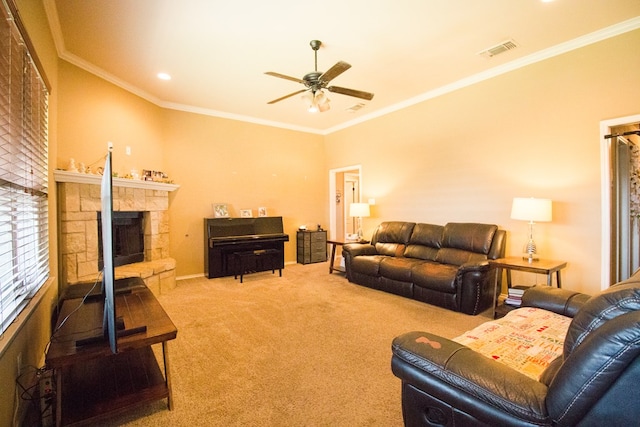 living room with a stone fireplace, visible vents, a ceiling fan, crown molding, and carpet flooring