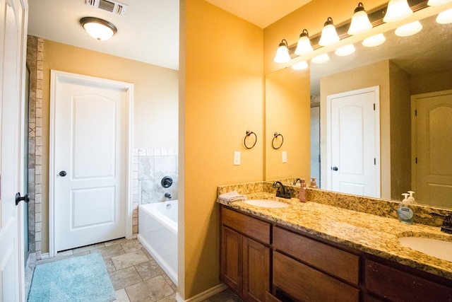 full bathroom with a garden tub, a sink, visible vents, and baseboards
