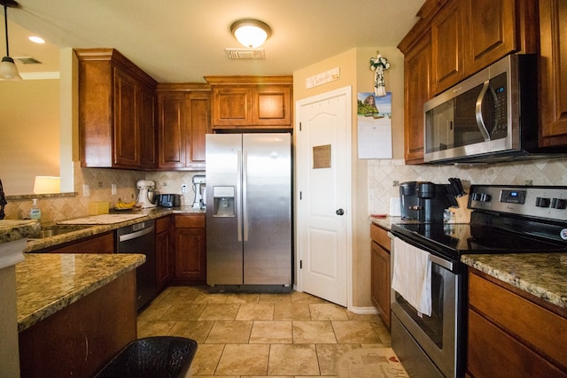 kitchen featuring decorative backsplash, stainless steel appliances, and visible vents