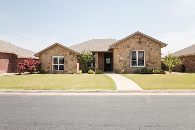 single story home with stone siding and a front yard