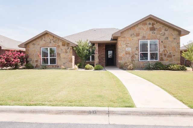 single story home with stone siding and a front lawn