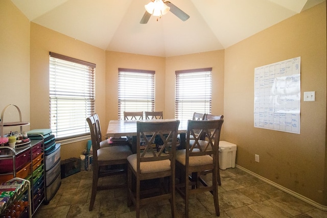 dining room with vaulted ceiling, a ceiling fan, and baseboards