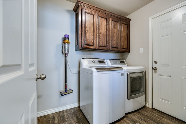 washroom featuring cabinets, dark hardwood / wood-style floors, and washer and dryer