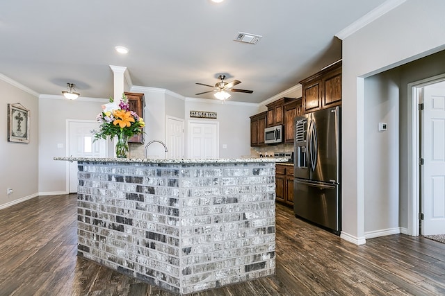 kitchen with stainless steel appliances, crown molding, light stone countertops, and dark wood-type flooring