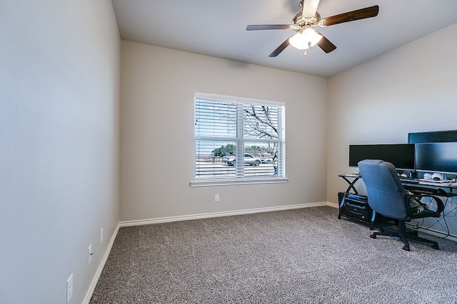 carpeted home office featuring ceiling fan