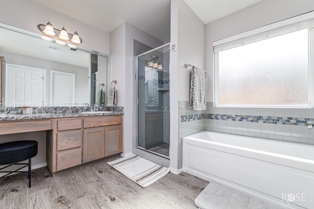 5033 Scarlet Oak Ln, San Angelo, TX 76904 - full bath with a stall shower, vanity, a bath, wood finished floors, and baseboards