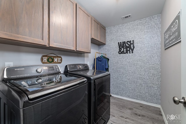 5033 Scarlet Oak Ln, San Angelo, TX 76904 - laundry room featuring cabinet space, washing machine and dryer, light wood-style flooring, and baseboards