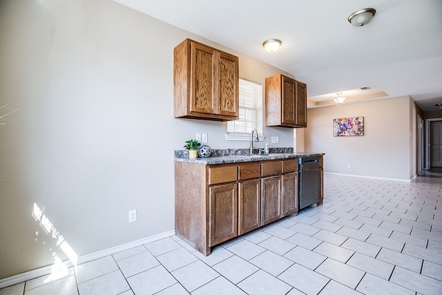 2902 Freeland St, San Angelo, TX 76901 - kitchen featuring dishwasher, baseboards, a sink, and light tile patterned floors