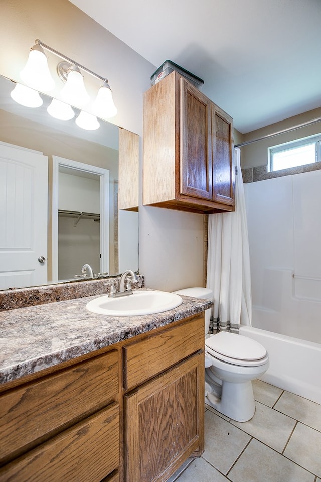 2902 Freeland St, San Angelo, TX 76901 - bathroom featuring vanity, shower / bath combination with curtain, toilet, and tile patterned floors