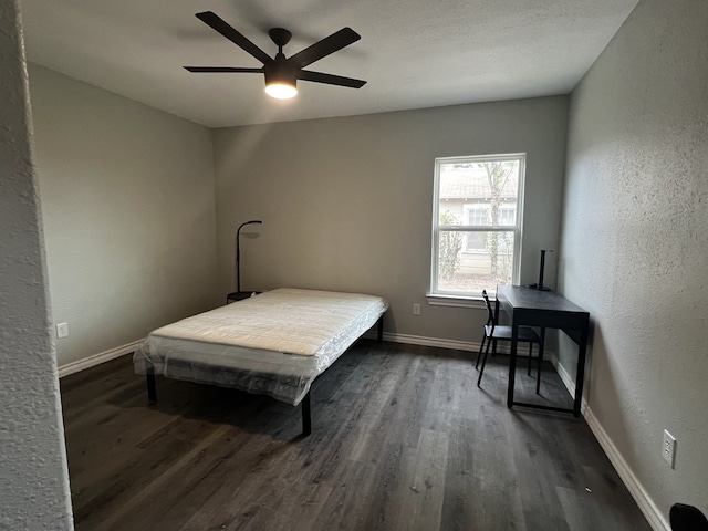 421 Howard St, San Angelo, TX 76901 - bedroom featuring wood finished floors, baseboards, a textured wall, and ceiling fan