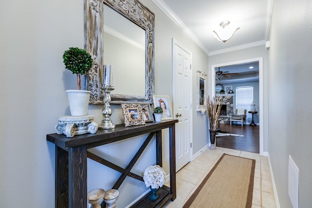 hallway with light tile patterned flooring and crown molding