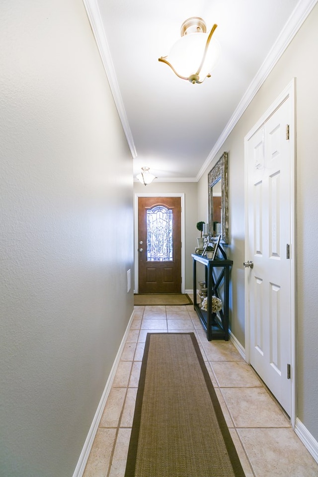 entryway featuring light tile patterned flooring and ornamental molding