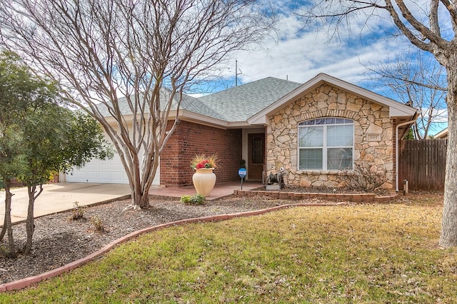 ranch-style home with a garage and a front yard