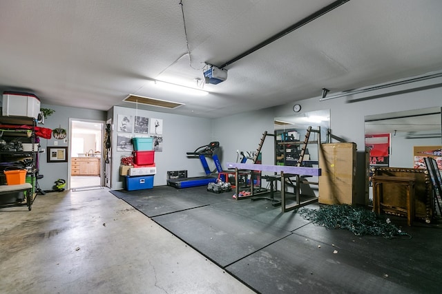 garage with a garage door opener and sink