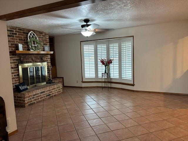 unfurnished living room with tile patterned flooring, ceiling fan, a fireplace, and a textured ceiling