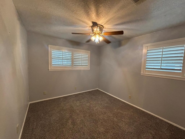 carpeted empty room with ceiling fan and a textured ceiling