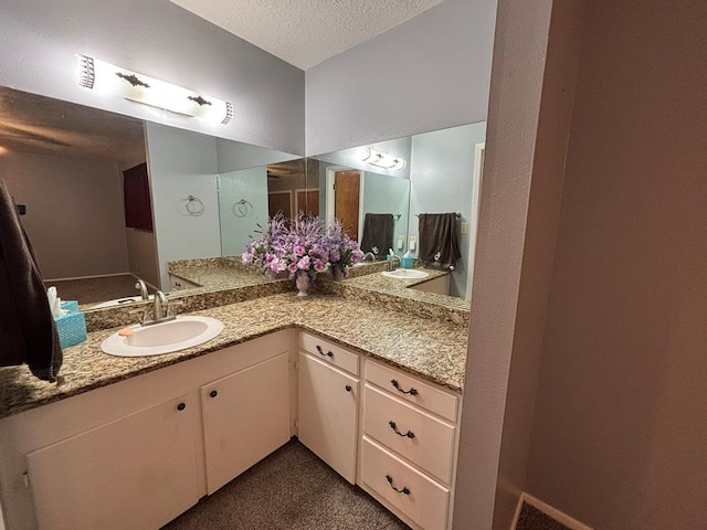 bathroom featuring vanity and a textured ceiling