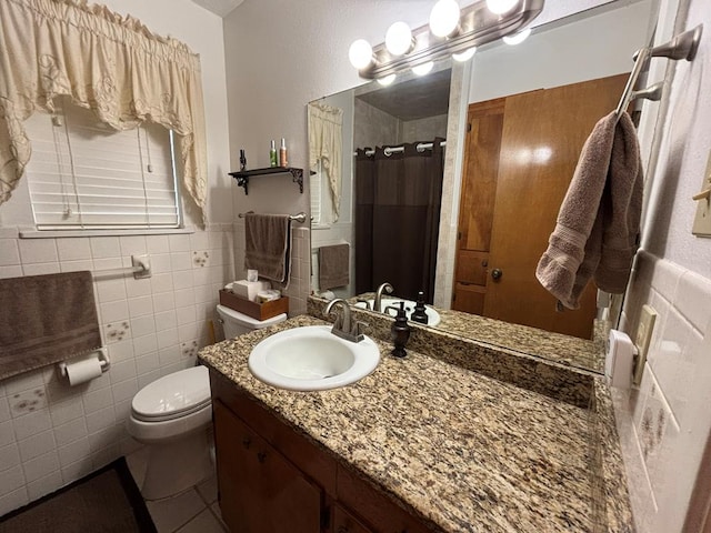 bathroom with walk in shower, vanity, toilet, and tile walls