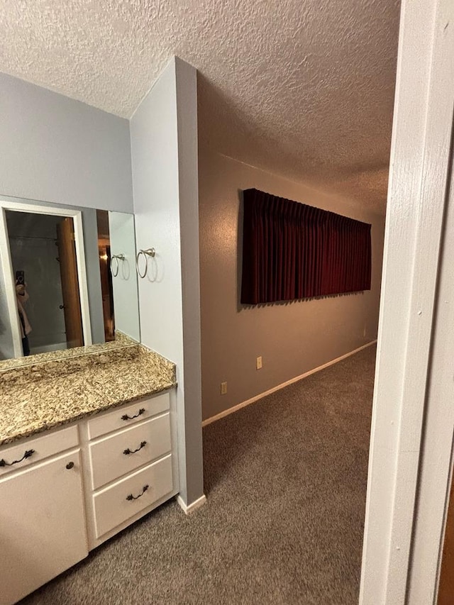 bathroom with vanity and a textured ceiling