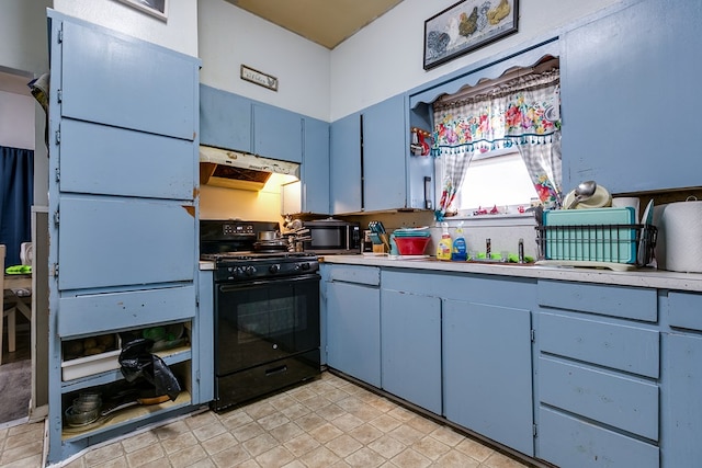 kitchen with black range with gas stovetop and blue cabinetry